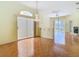 Open living space with sliding glass doors, elegant chandeliers, and warm parquet flooring at 13542 Norman Cir, Hudson, FL 34669