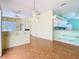 Spacious living area boasts parquet floors, chandelier, and an open layout to the kitchen at 13542 Norman Cir, Hudson, FL 34669