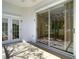 Covered patio with tile flooring, sliding glass doors and a white door with glass panels at 13542 Norman Cir, Hudson, FL 34669