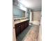 Cozy bathroom featuring a shower-tub combo, double vanity with granite countertop, and neutral tile flooring at 13856 Crest Lake Dr, Hudson, FL 34669