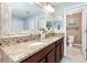 Bathroom features a double sink vanity with granite countertops and a neutral color palette at 13856 Crest Lake Dr, Hudson, FL 34669