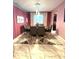 Formal dining room with a modern chandelier and large window at 13856 Crest Lake Dr, Hudson, FL 34669