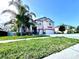 Charming two-story home with a large driveway, attached two-car garage, and a well-manicured front lawn at 13856 Crest Lake Dr, Hudson, FL 34669