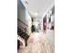 Elegant foyer with marble floors, a staircase, and decorative shelving, creating a grand entrance at 13856 Crest Lake Dr, Hudson, FL 34669