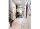 Bright hallway features marble floors, white-washed walls, and stylish decor at 13856 Crest Lake Dr, Hudson, FL 34669