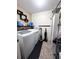 Convenient laundry room with appliances, storage shelves, and functional layout at 13856 Crest Lake Dr, Hudson, FL 34669