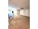 Expansive carpeted loft area with multiple doors, a ceiling fan, and ample space at 13856 Crest Lake Dr, Hudson, FL 34669