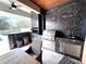 Outdoor kitchen with a built-in grill, bar, and sleek countertops, ideal for outdoor dining at 13856 Crest Lake Dr, Hudson, FL 34669