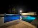 Stunning pool at night with colorful lighting, creating a relaxing and inviting ambiance at 13856 Crest Lake Dr, Hudson, FL 34669