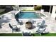 Inviting pool area with a fire pit and seating, perfect for outdoor relaxation and entertainment at 13856 Crest Lake Dr, Hudson, FL 34669