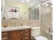 Bathroom featuring a shower, tile walls, and a wood vanity with plenty of storage at 13920 Pinecrest Dr, Largo, FL 33774