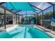 Refreshing pool area with comfortable chairs and shade, perfect for relaxation and entertaining guests at 13920 Pinecrest Dr, Largo, FL 33774