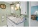 Bathroom featuring stylish hanging lights, marble countertops and a mirrored vanity at 1400 1St W Ave # G1, Bradenton, FL 34205