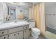 Bright bathroom features a spacious vanity and a shower-tub combination with a shower curtain at 1400 1St W Ave # G1, Bradenton, FL 34205