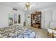 Bright bedroom features a ceiling fan, an eclectic bookshelf and a large mirror on the wall at 1400 1St W Ave # G1, Bradenton, FL 34205