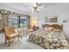 Bright bedroom features a classic wooden headboard, coordinated floral bedding and direct window light at 1400 1St W Ave # G1, Bradenton, FL 34205