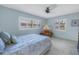 Comfortable bedroom showcasing a window with plantation shutters and a cozy armchair by the window at 1400 1St W Ave # G1, Bradenton, FL 34205