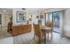 Cozy dining area boasts a wooden table with wicker chairs and is illuminated by a charming decorative chandelier at 1400 1St W Ave # G1, Bradenton, FL 34205