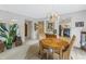 Open dining area featuring a wooden table with wicker chairs, decorative chandelier and easy access to the kitchen at 1400 1St W Ave # G1, Bradenton, FL 34205