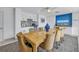 Dining room with kitchen access, featuring a large table, comfortable seating, and a stylish blue accent wall at 1400 1St W Ave # G1, Bradenton, FL 34205
