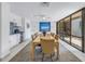 Spacious dining room with elegant chairs, a large dining table, and a modern ceiling fan at 1400 1St W Ave # G1, Bradenton, FL 34205