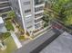 An exterior view of a condo building with multiple balconies, landscaping, and a street view at 1400 1St W Ave # G1, Bradenton, FL 34205