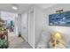 Bright hallway with tiled flooring, closet doors, and stylish decor leading to the living area at 1400 1St W Ave # G1, Bradenton, FL 34205