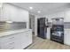 This stylish kitchen features stainless steel appliances, white cabinets, and ample counter space at 1400 1St W Ave # G1, Bradenton, FL 34205