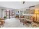 Welcoming living room features comfortable wicker furniture, ceiling fan and large sliding glass door to the private patio at 1400 1St W Ave # G1, Bradenton, FL 34205