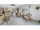 Comfortable living room featuring casual wicker furniture, and access to the dining area and a bright window at 1400 1St W Ave # G1, Bradenton, FL 34205