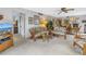 Comfortable living room featuring casual wicker furniture, ceiling fan and open access to the dining area at 1400 1St W Ave # G1, Bradenton, FL 34205