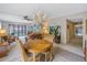 Bright living room featuring a dining area, decorative chandelier, ceiling fan and a large sliding glass door to a private deck at 1400 1St W Ave # G1, Bradenton, FL 34205