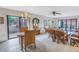 Inviting living room features classic wicker furniture, a decorative chandelier, and sliding glass door to a beautifully landscaped patio at 1400 1St W Ave # G1, Bradenton, FL 34205