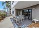 Cozy patio area with an outdoor dining set and serene garden surroundings at 1400 1St W Ave # G1, Bradenton, FL 34205
