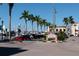 Charming street view with waterfront access, palm trees and Twin Dolphin marina sign at 1400 1St W Ave # G1, Bradenton, FL 34205
