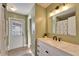 Bathroom vanity with a white marble top, updated fixtures, and an exterior door at 1425 Monte Lake Dr, Valrico, FL 33596