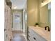 Bathroom featuring a tiled shower, a new vanity with a mirror, and an exterior door at 1425 Monte Lake Dr, Valrico, FL 33596