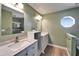 Updated bathroom featuring a double vanity with marble countertops and modern fixtures at 1425 Monte Lake Dr, Valrico, FL 33596