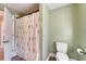 Bathroom featuring an updated toilet, decorative shower curtain, and modern features at 1425 Monte Lake Dr, Valrico, FL 33596