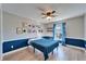 Bright bedroom boasts natural light, blue accents, fan, and charming superhero themed decorations at 1425 Monte Lake Dr, Valrico, FL 33596