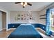 Bedroom featuring a ceiling fan, superhero art, a window, and blue accents at 1425 Monte Lake Dr, Valrico, FL 33596