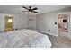 Bedroom with neutral walls, wood floors, and a doorway leading to an en-suite bathroom at 1425 Monte Lake Dr, Valrico, FL 33596