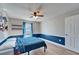 Bedroom featuring a ceiling fan, natural light, blue accents, and door at 1425 Monte Lake Dr, Valrico, FL 33596