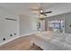 Bright bedroom with wood floors and a sliding door leads to a backyard pool at 1425 Monte Lake Dr, Valrico, FL 33596