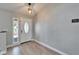 Light and airy foyer with wood-look floors, and a modern light fixture at 1425 Monte Lake Dr, Valrico, FL 33596