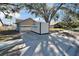 A well-maintained home with a garage and mature trees providing shade in the front yard at 1425 Monte Lake Dr, Valrico, FL 33596