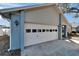 A well-lit garage door with decorative windows adds curb appeal to this home's exterior at 1425 Monte Lake Dr, Valrico, FL 33596