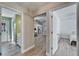 Inviting hallway with light grey wood floors, leading to the kitchen and bedrooms at 1425 Monte Lake Dr, Valrico, FL 33596
