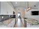 Modern kitchen features granite counters, stainless steel appliances, and an island with a sink at 1425 Monte Lake Dr, Valrico, FL 33596