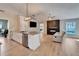 Open concept living room/kitchen, hardwood floors, ceiling fan, modern lighting, fireplace and electric fireplace at 1425 Monte Lake Dr, Valrico, FL 33596